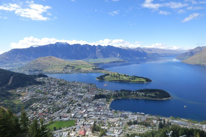 A view of a city and a lake with mountains in the background