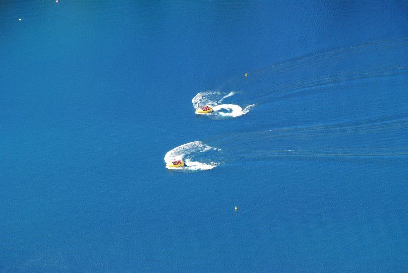 Two people are riding a jet ski in the ocean.