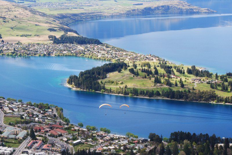 An aerial view of a lake with a small island in the middle.