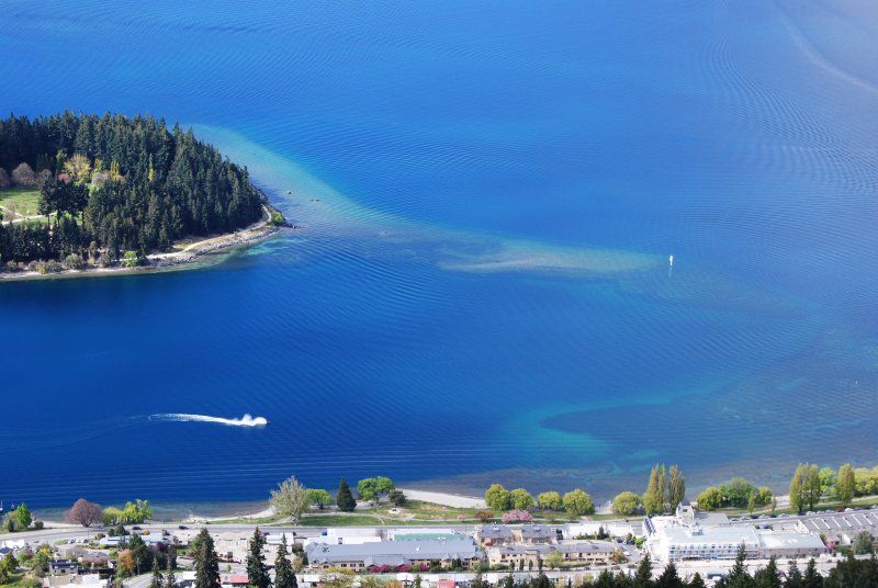 An aerial view of a lake with a small island in the middle.