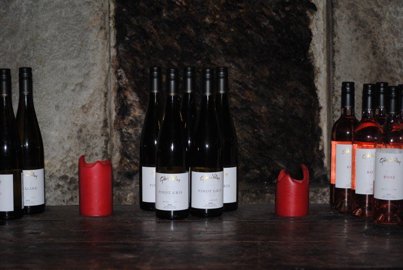 Several bottles of wine are lined up on a table