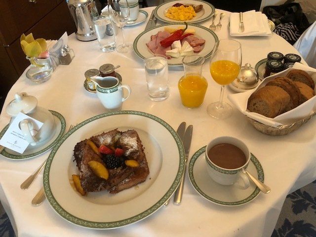 A table topped with plates of food and a cup of coffee
