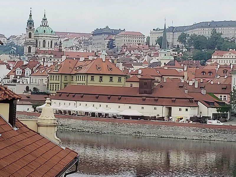 A view of a city with a river in the foreground