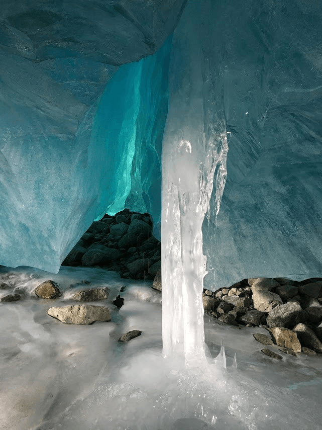 A large ice pillar in the middle of an ice cave.