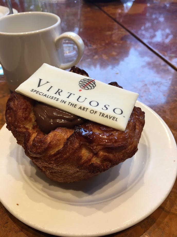 A pastry on a plate that says virtuoso on it