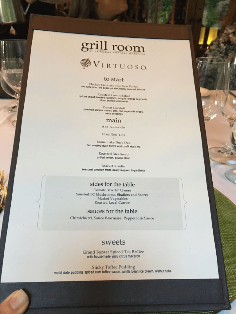 A person is holding a menu for the grill room