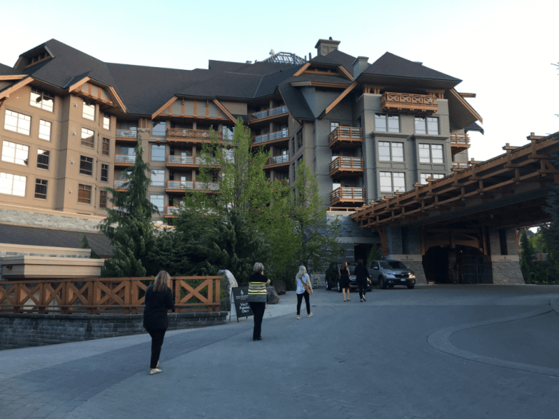 A group of people walking in front of a large building