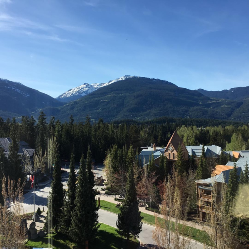 An aerial view of a city with mountains in the background