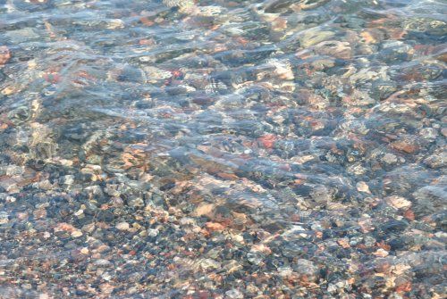 A close up of a body of water surrounded by rocks.