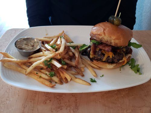 A white plate topped with a hamburger and french fries