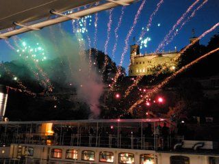 A boat with fireworks going off in the background