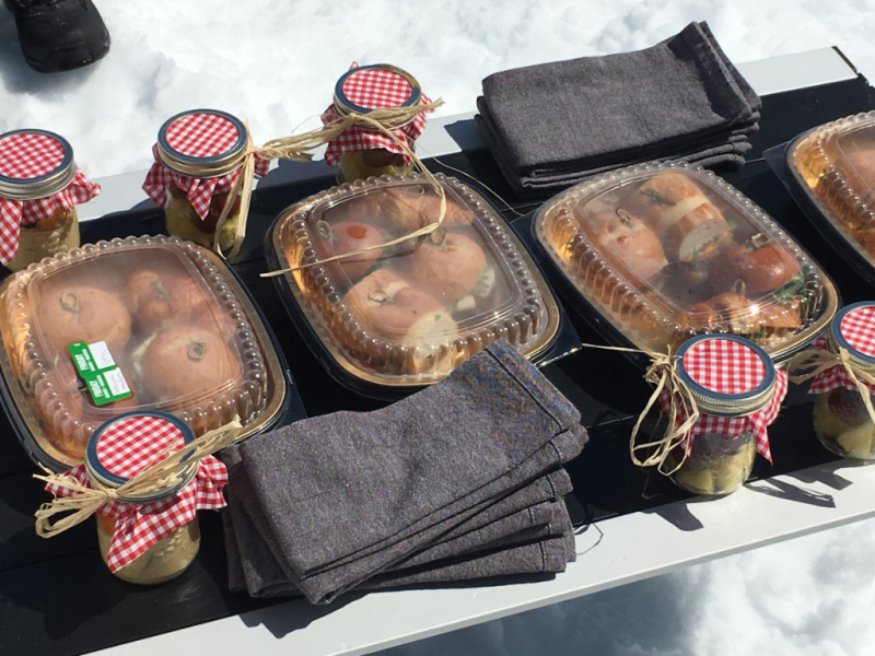 A table with containers of food and napkins on it
