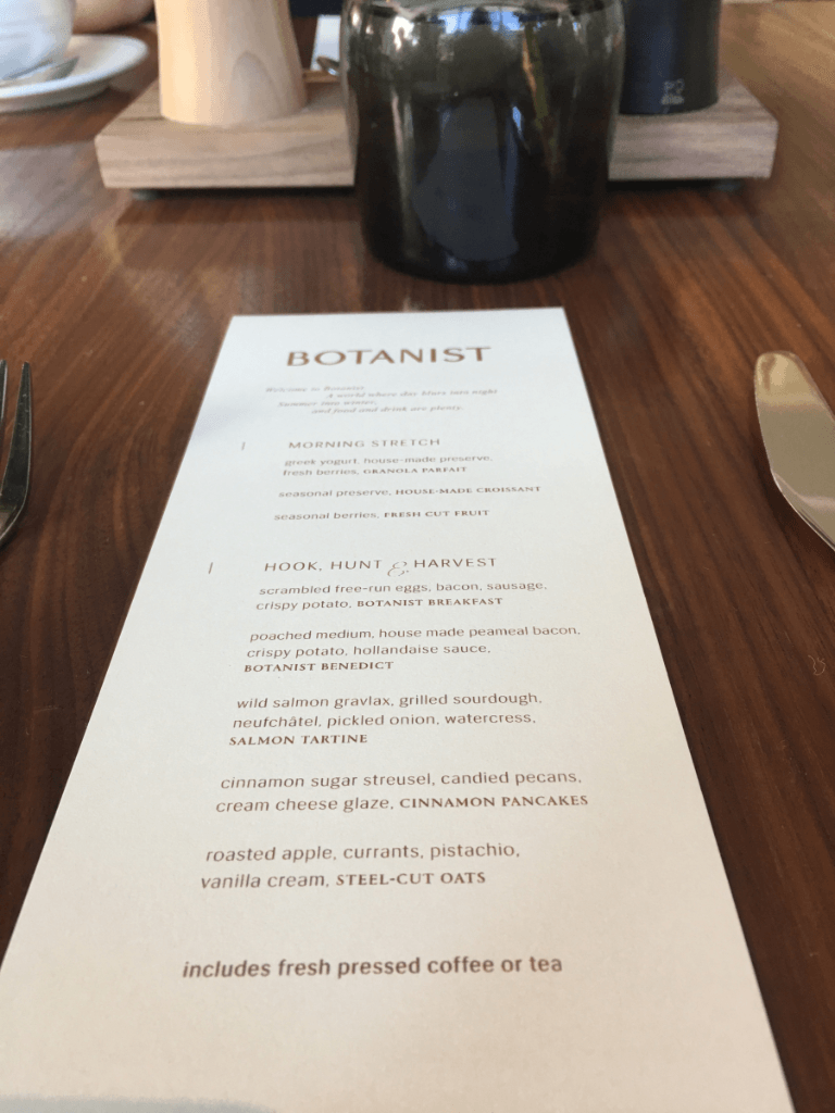 A menu for the botanist restaurant is on a wooden table