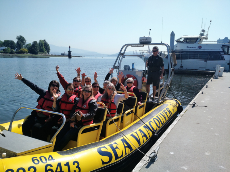 A group of people on a yellow sea vancouver boat