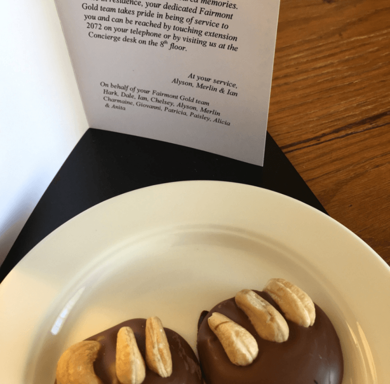 A white plate with two chocolate covered cookies on it