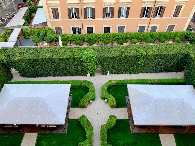 An aerial view of a garden with a building in the background