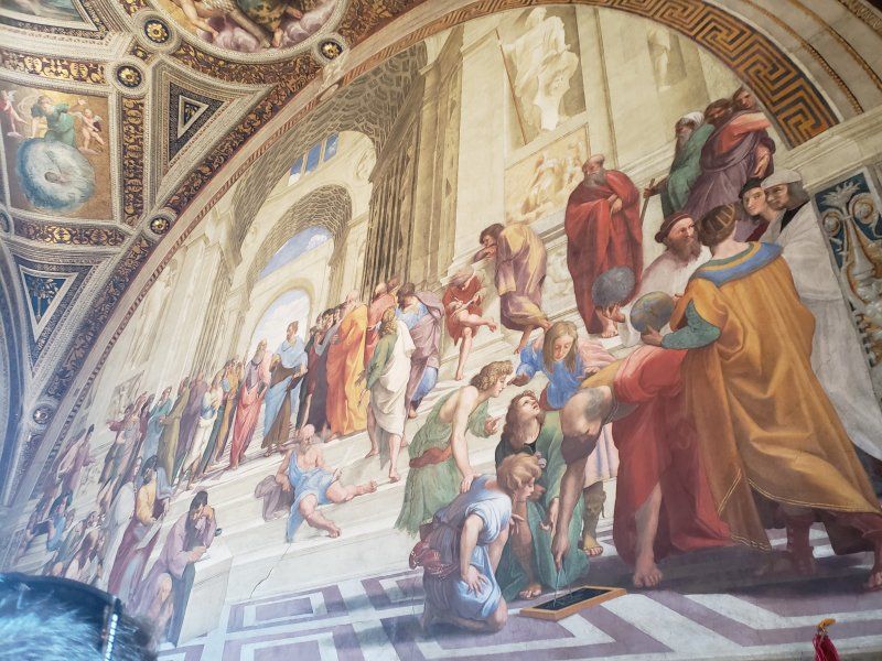 A painting of a group of people on a wall