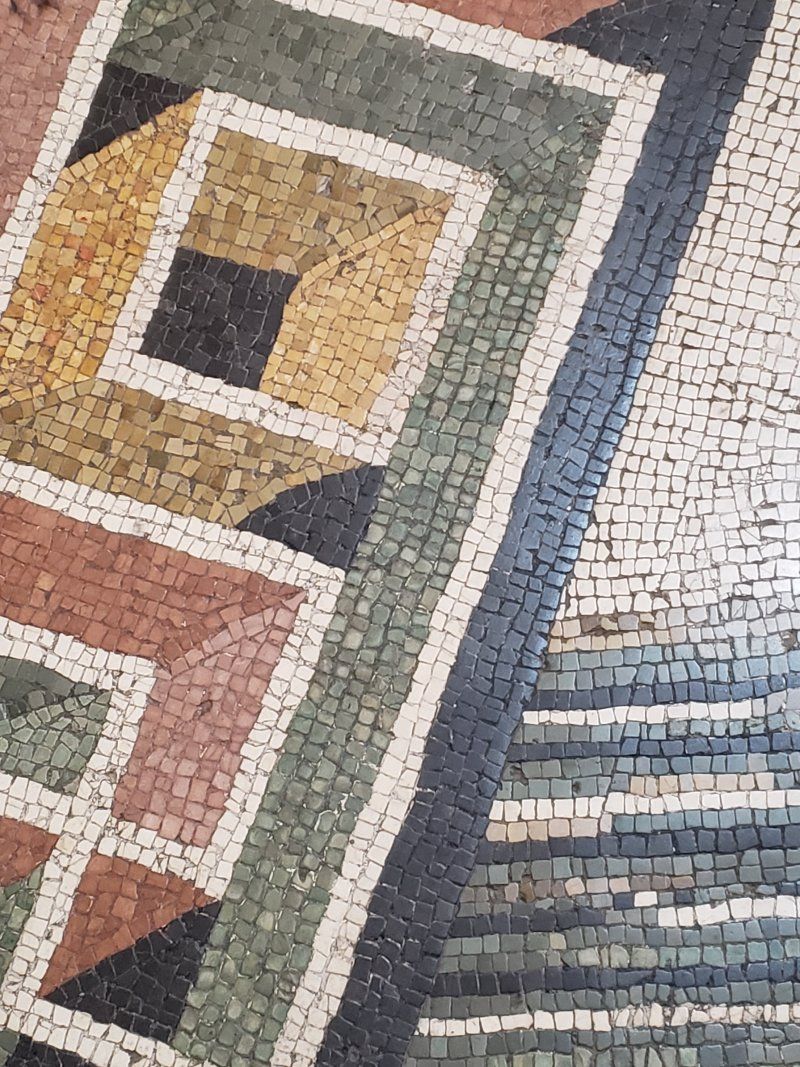 A close up of a mosaic floor with a geometric pattern
