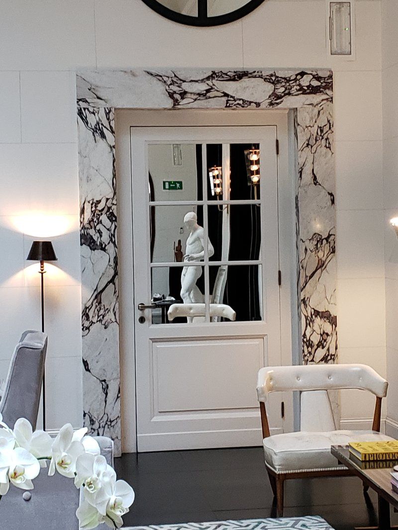 A living room with a statue in the doorway