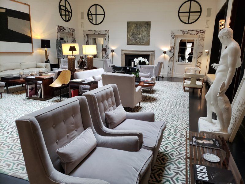 A living room filled with furniture and a statue of a man