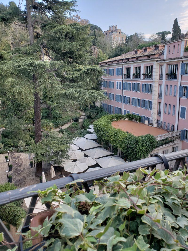 A view of a city from a balcony with a building in the background