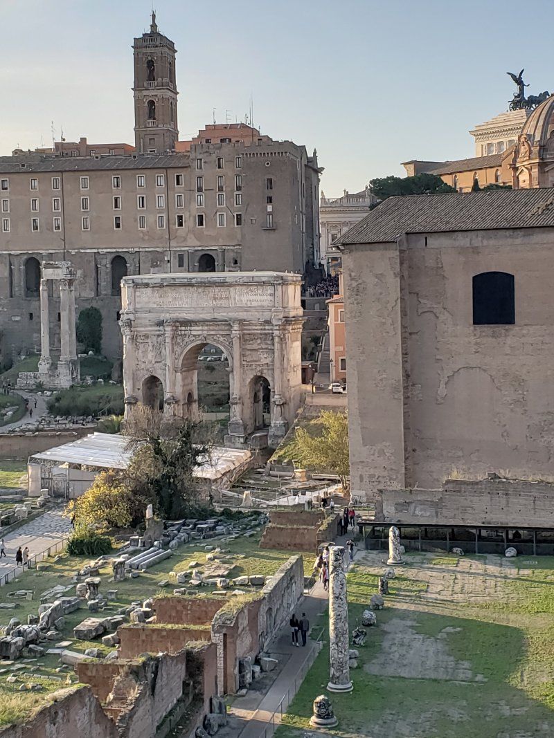 An aerial view of a city with a large building in the background