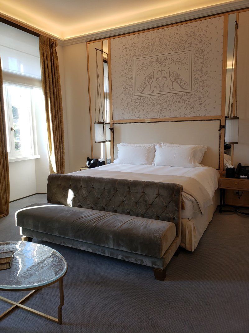 A hotel room with a large bed , couch , and coffee table.