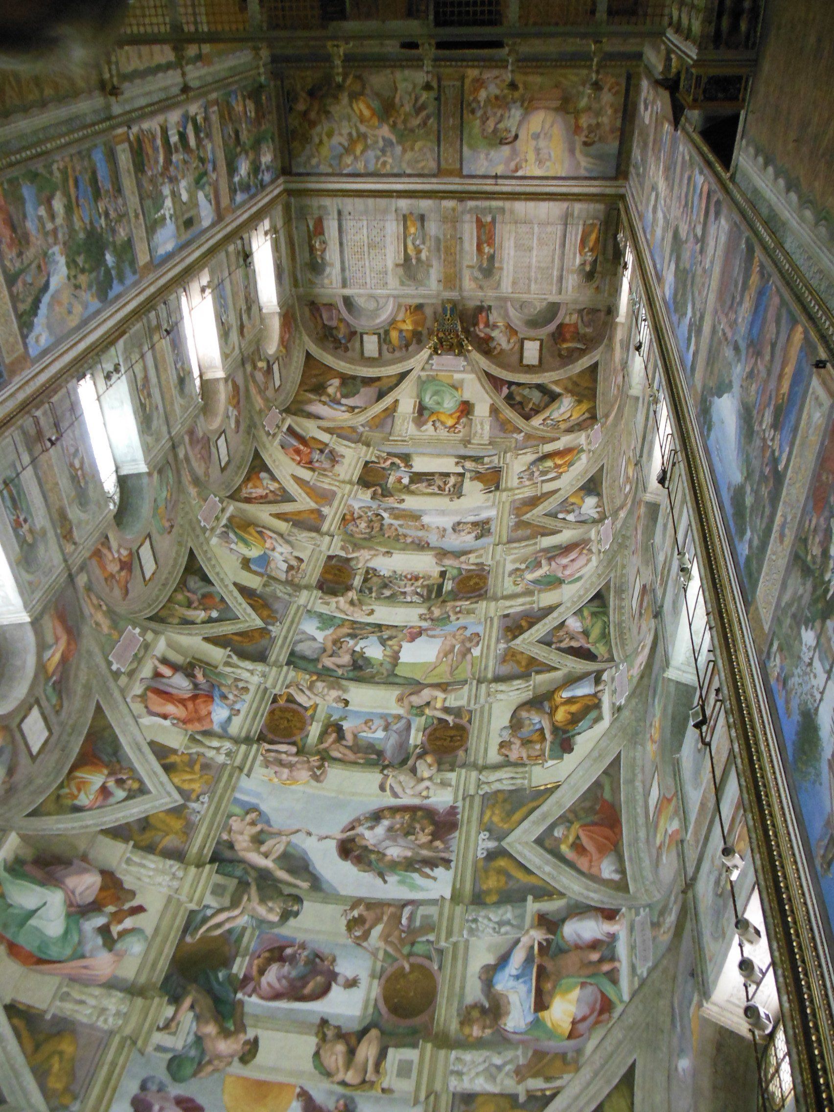 A large room with a lot of paintings on the ceiling.