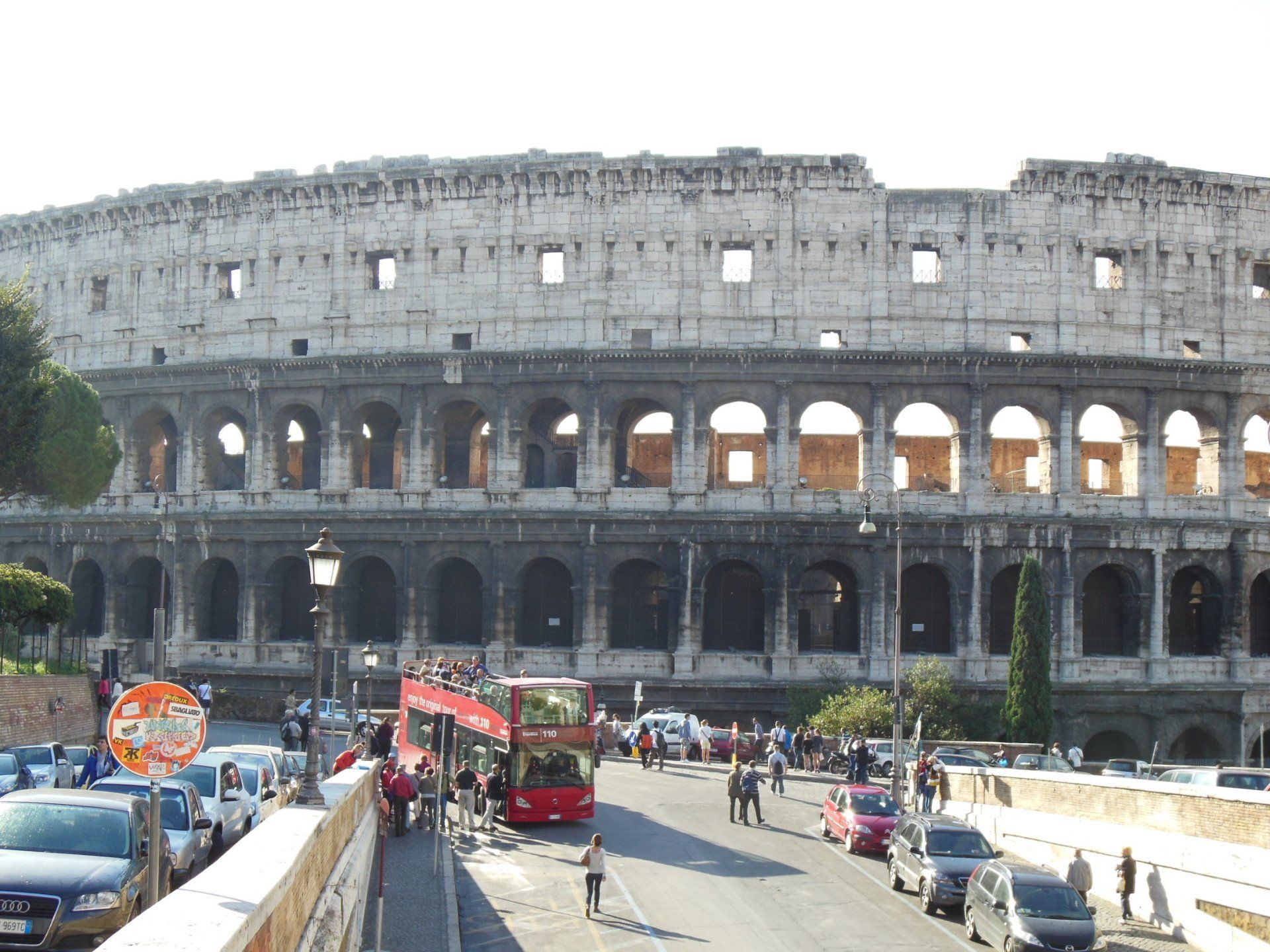 A busy street in front of the colosseum in rome