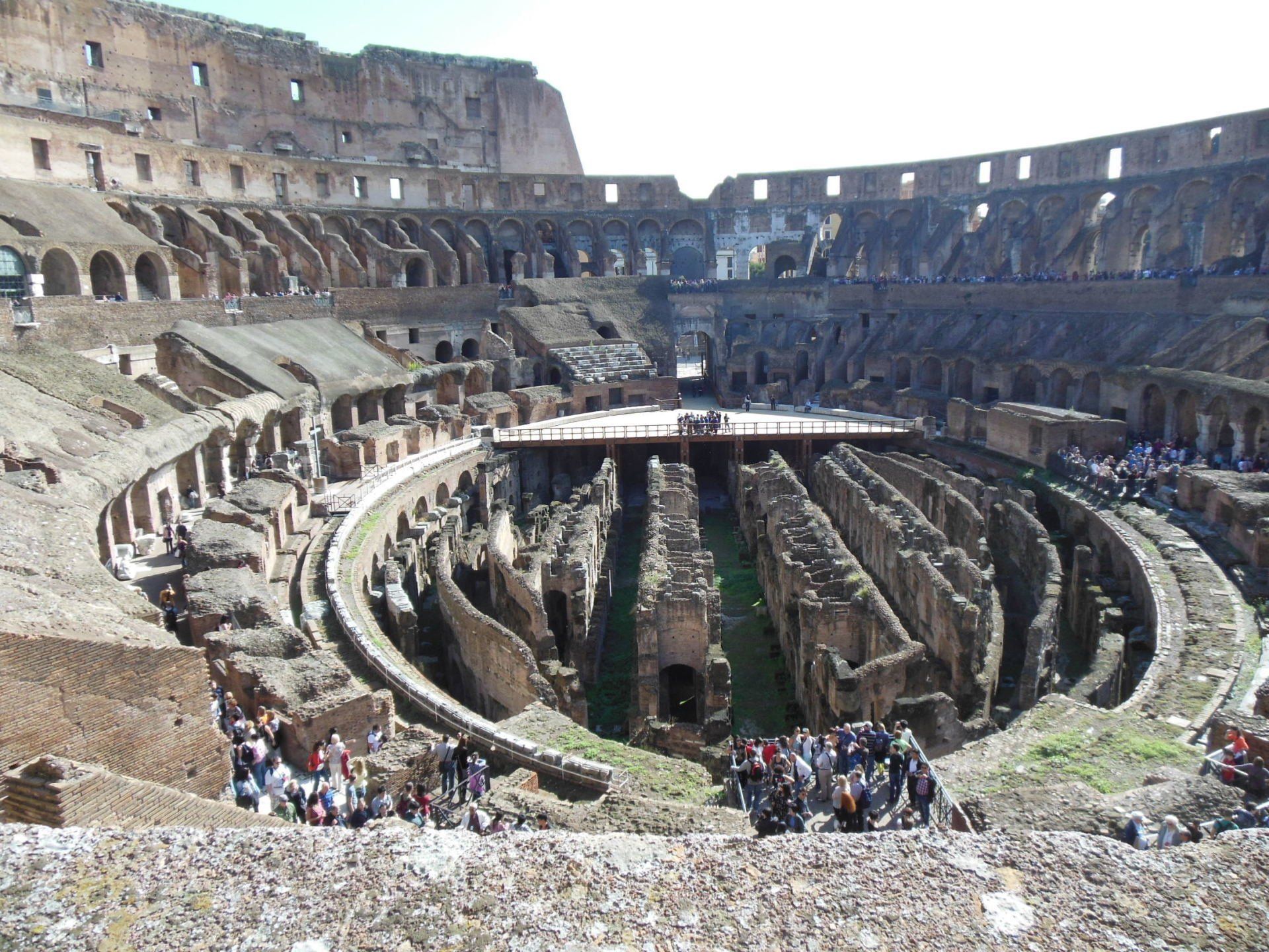 A group of people are standing in an ancient amphitheater