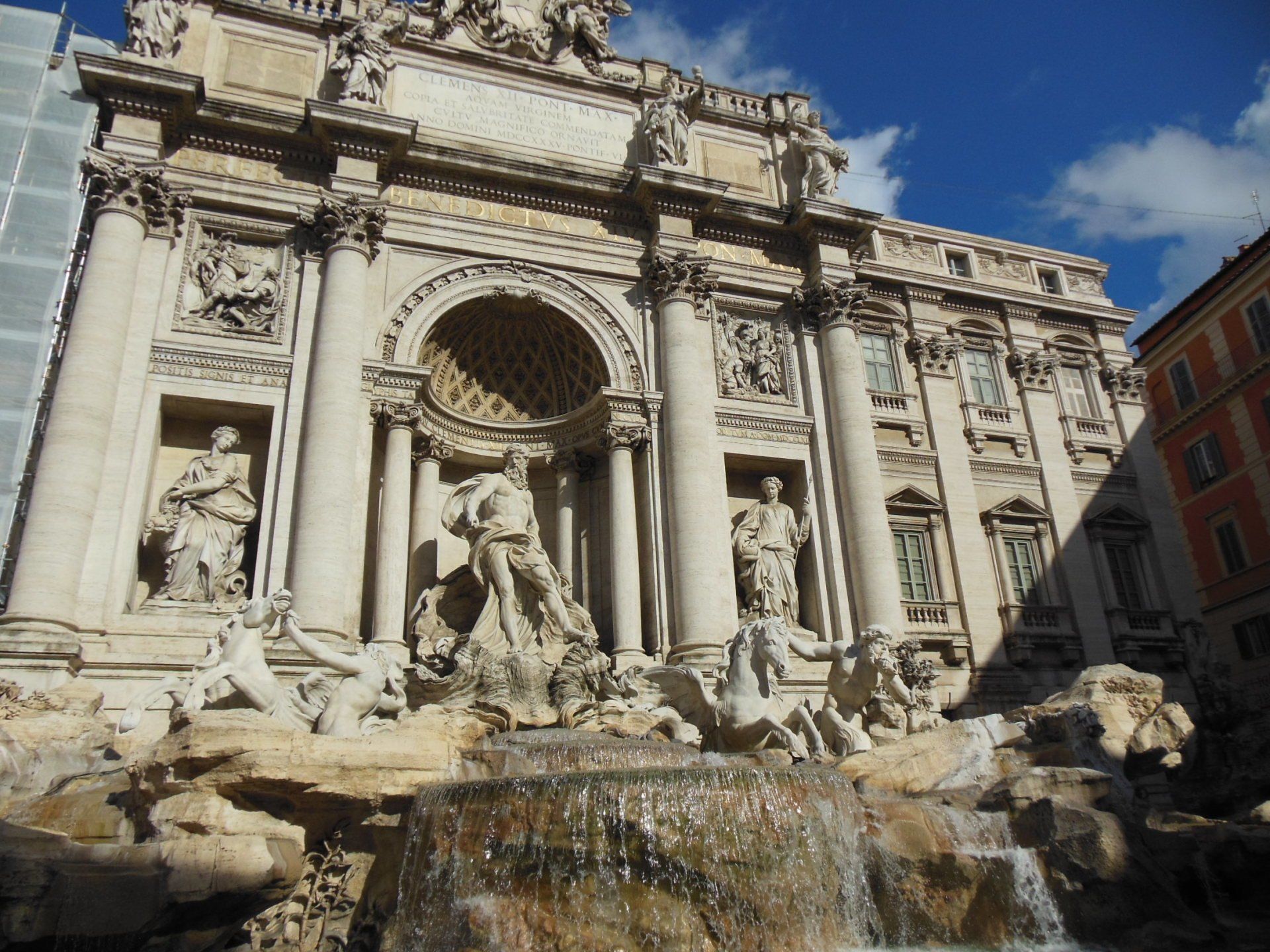 A large building with a fountain in front of it