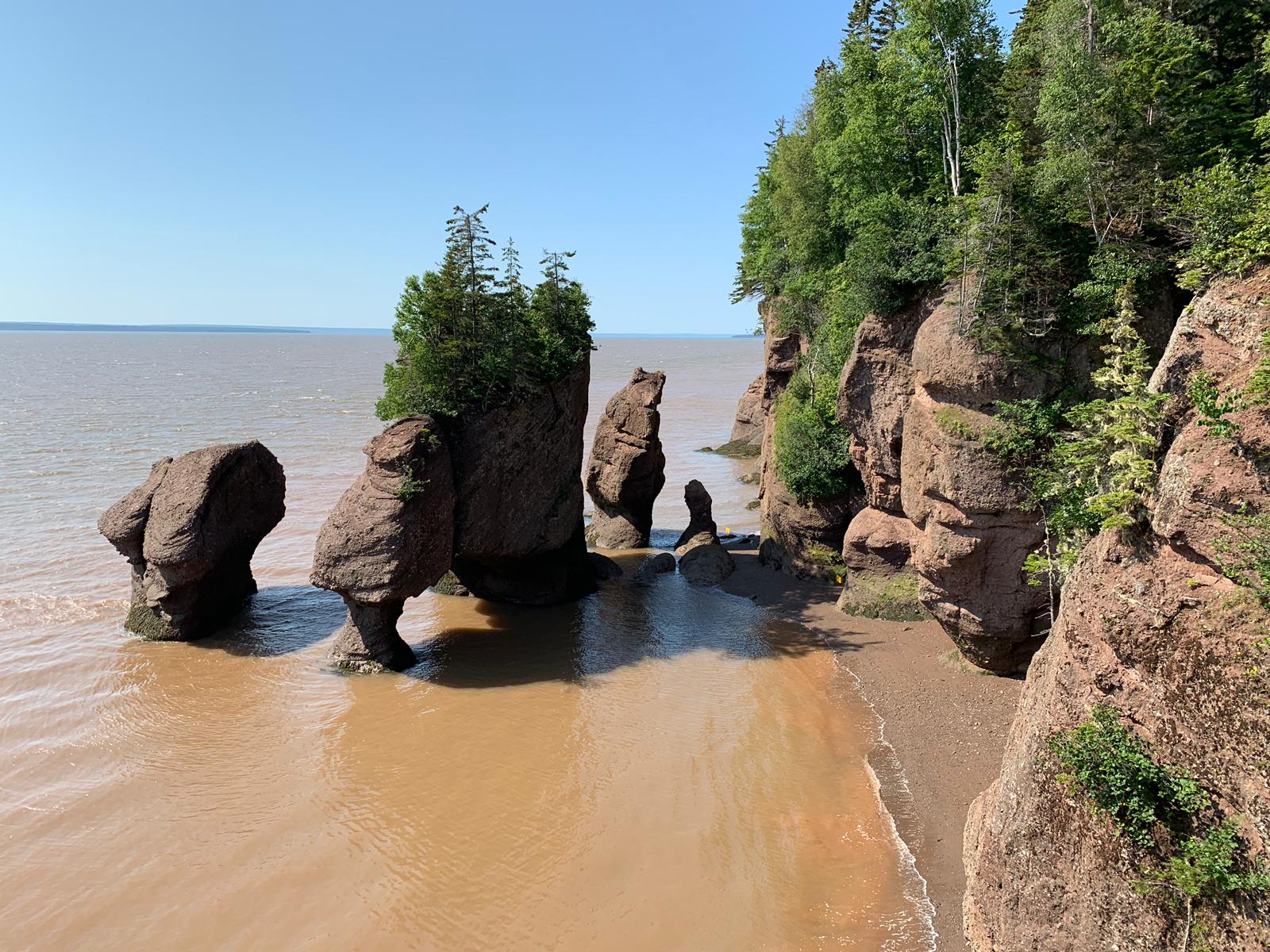 A large rock formation in the middle of a body of water.