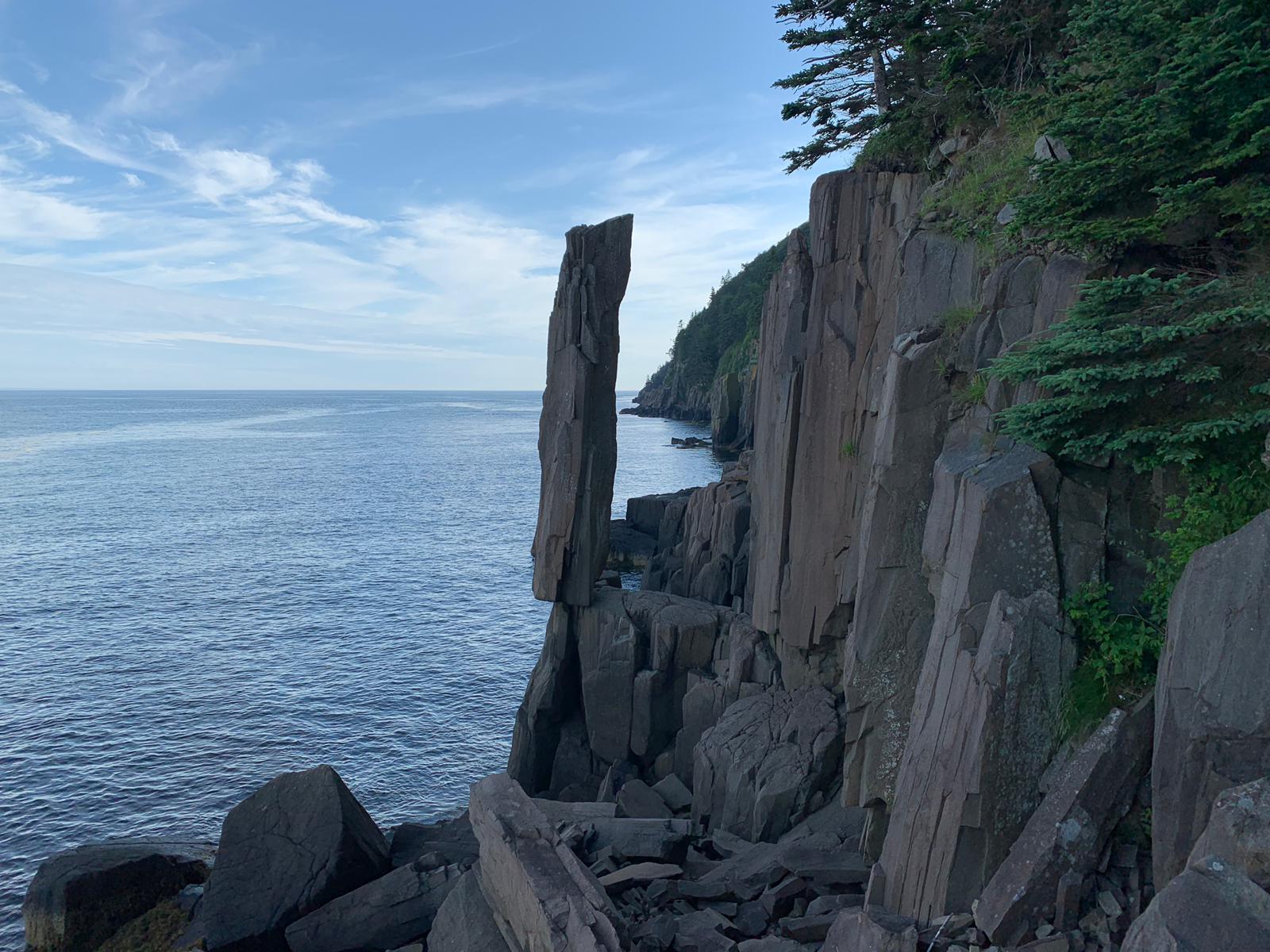 A rocky cliff overlooking a body of water