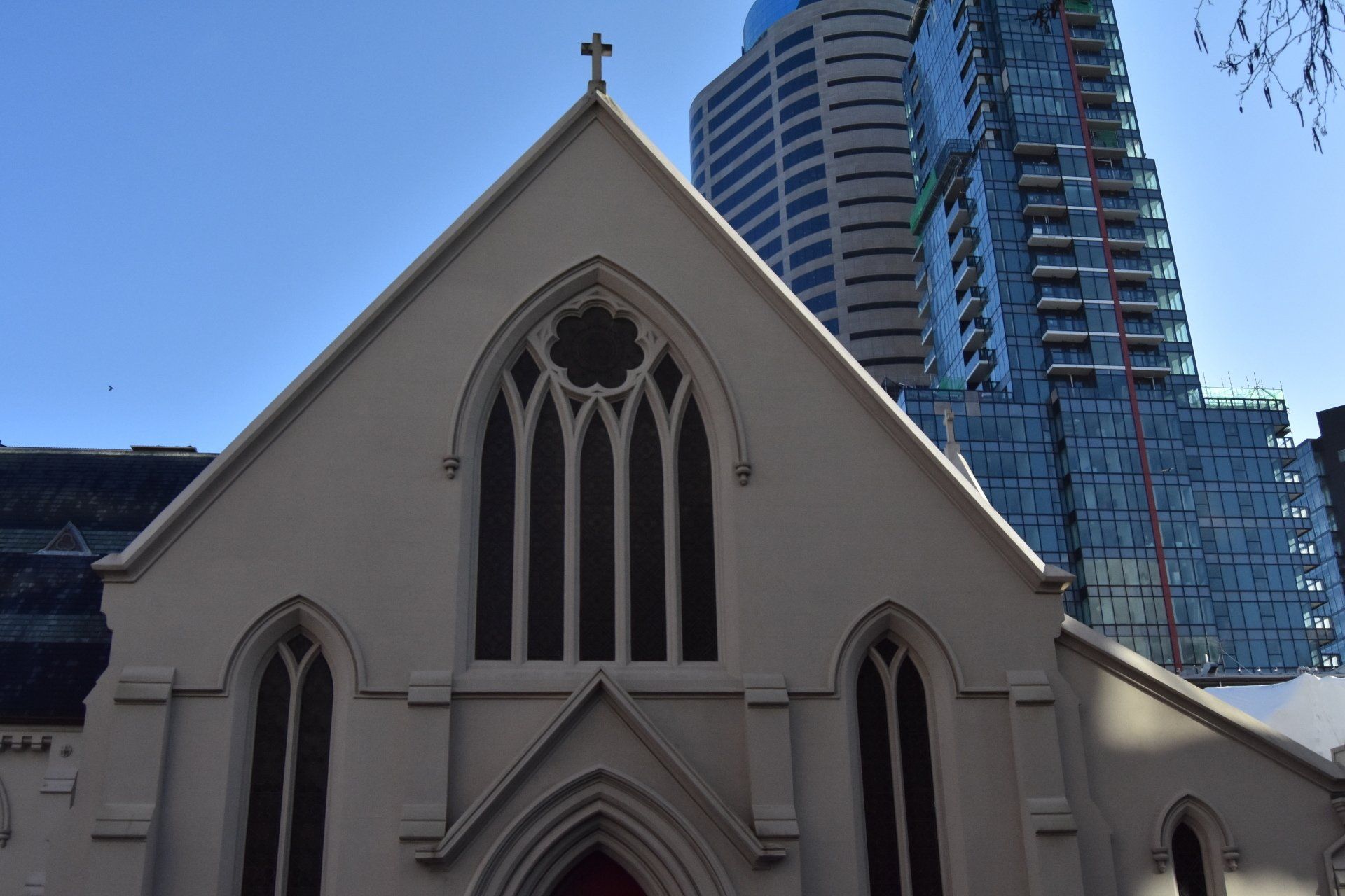 A church with a tall building in the background