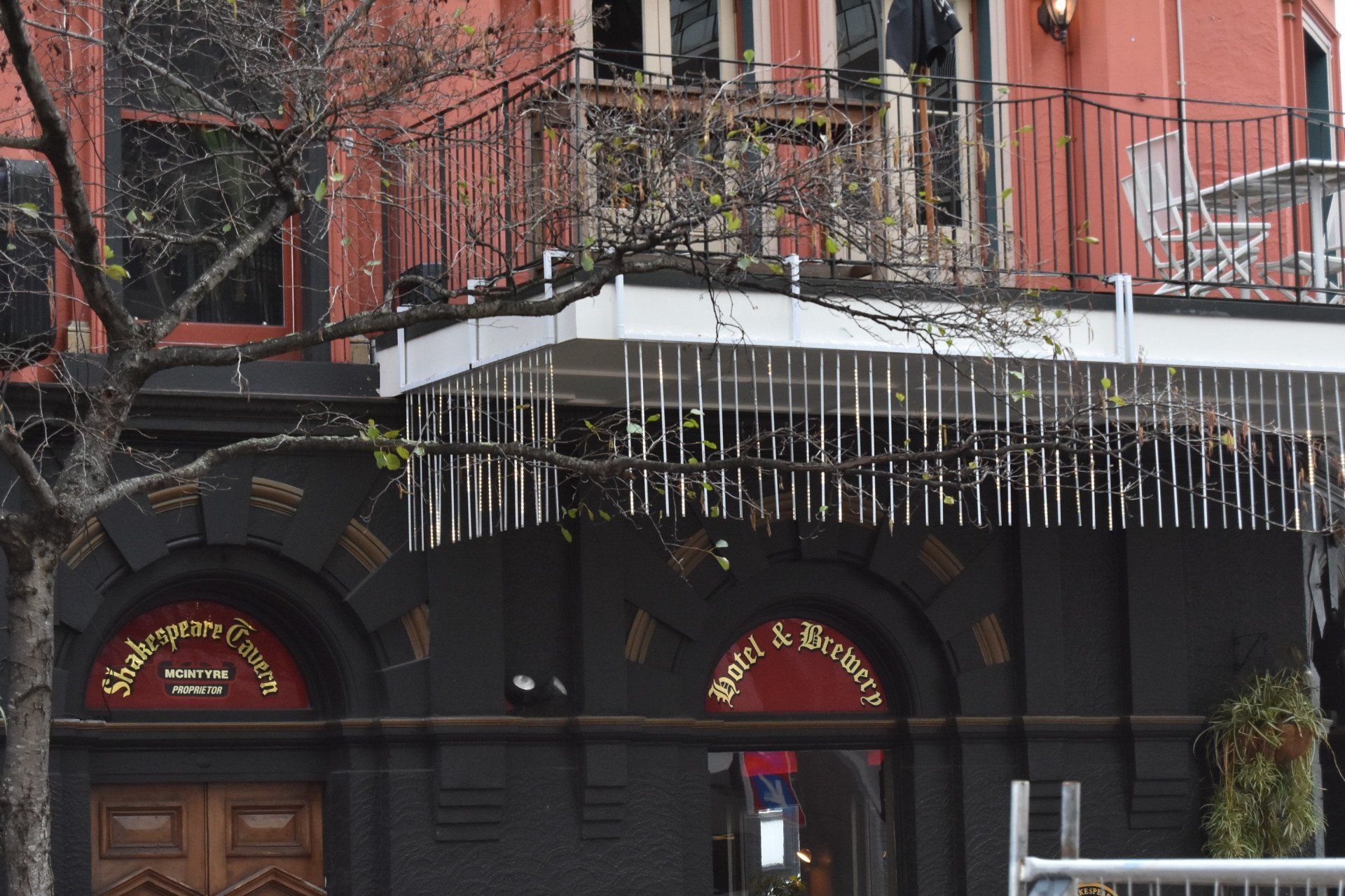 A building with a balcony and christmas lights on it