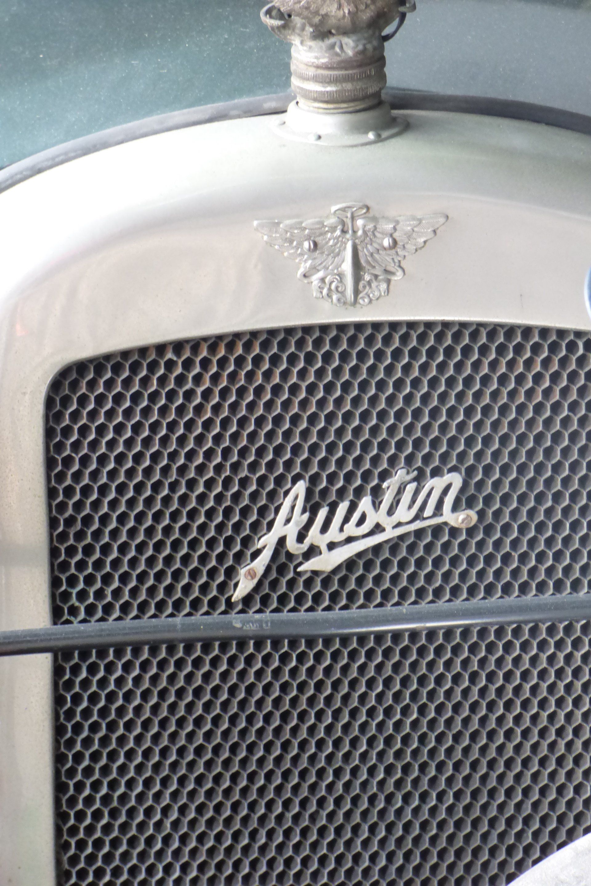 A close up of the front of an old austin car