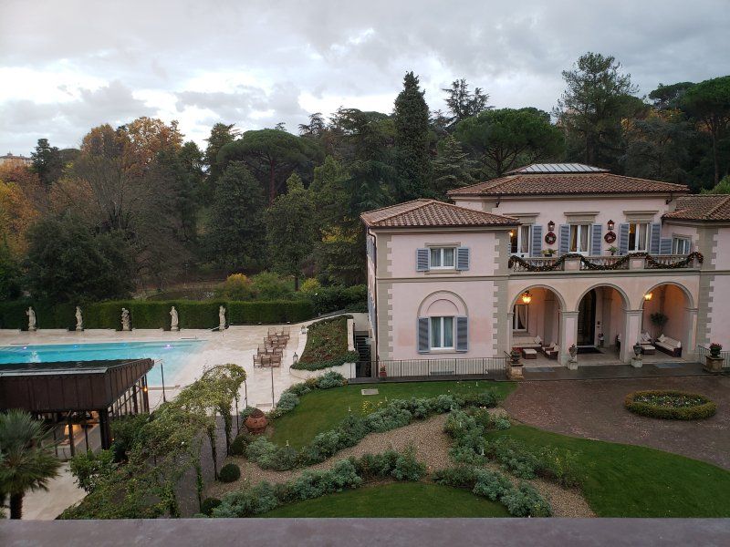 A large house with a swimming pool in front of it