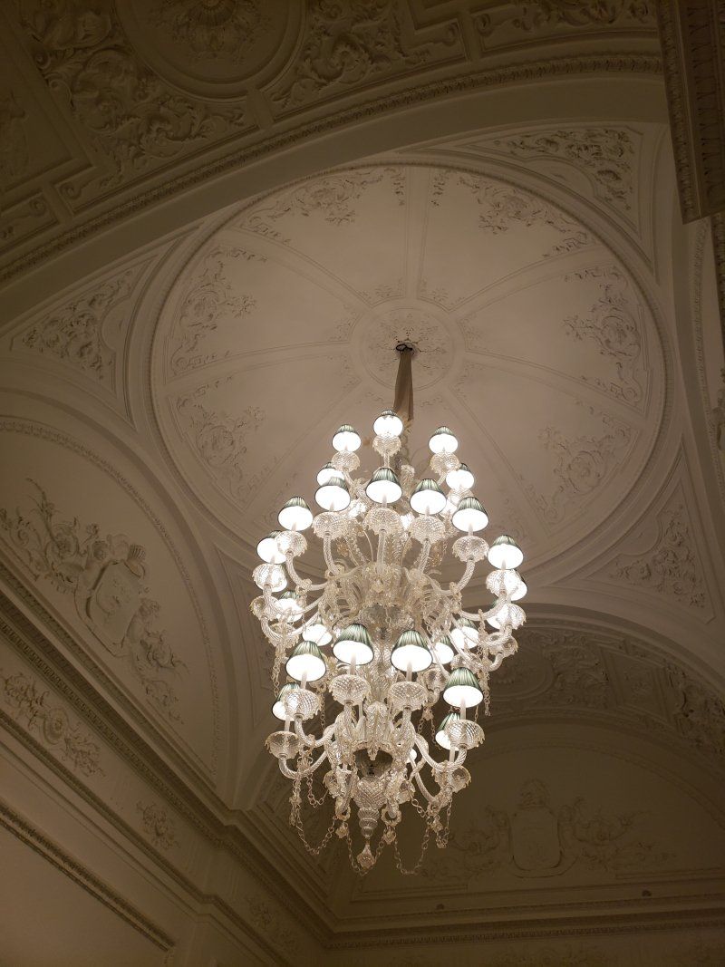A large chandelier is hanging from the ceiling of a building