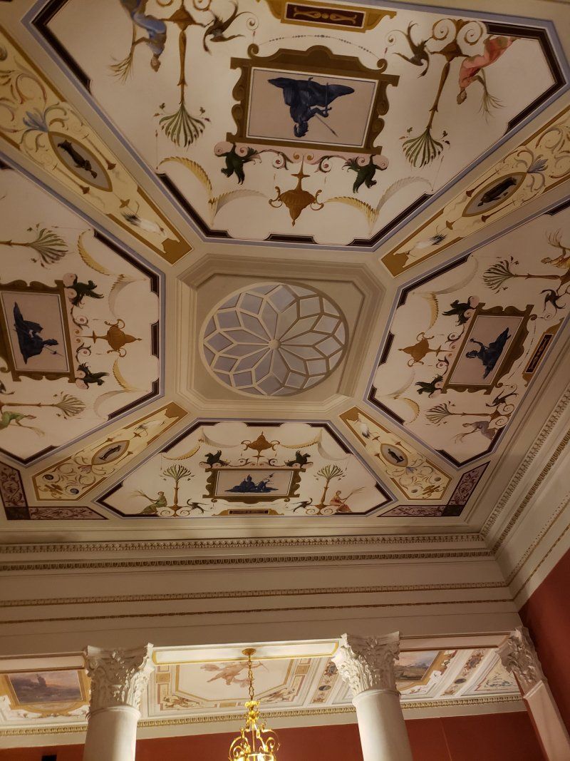 A ceiling with a chandelier hanging from it