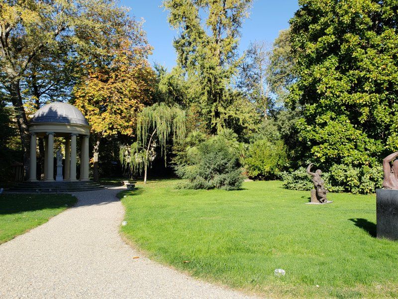 A path in a park with a gazebo in the background