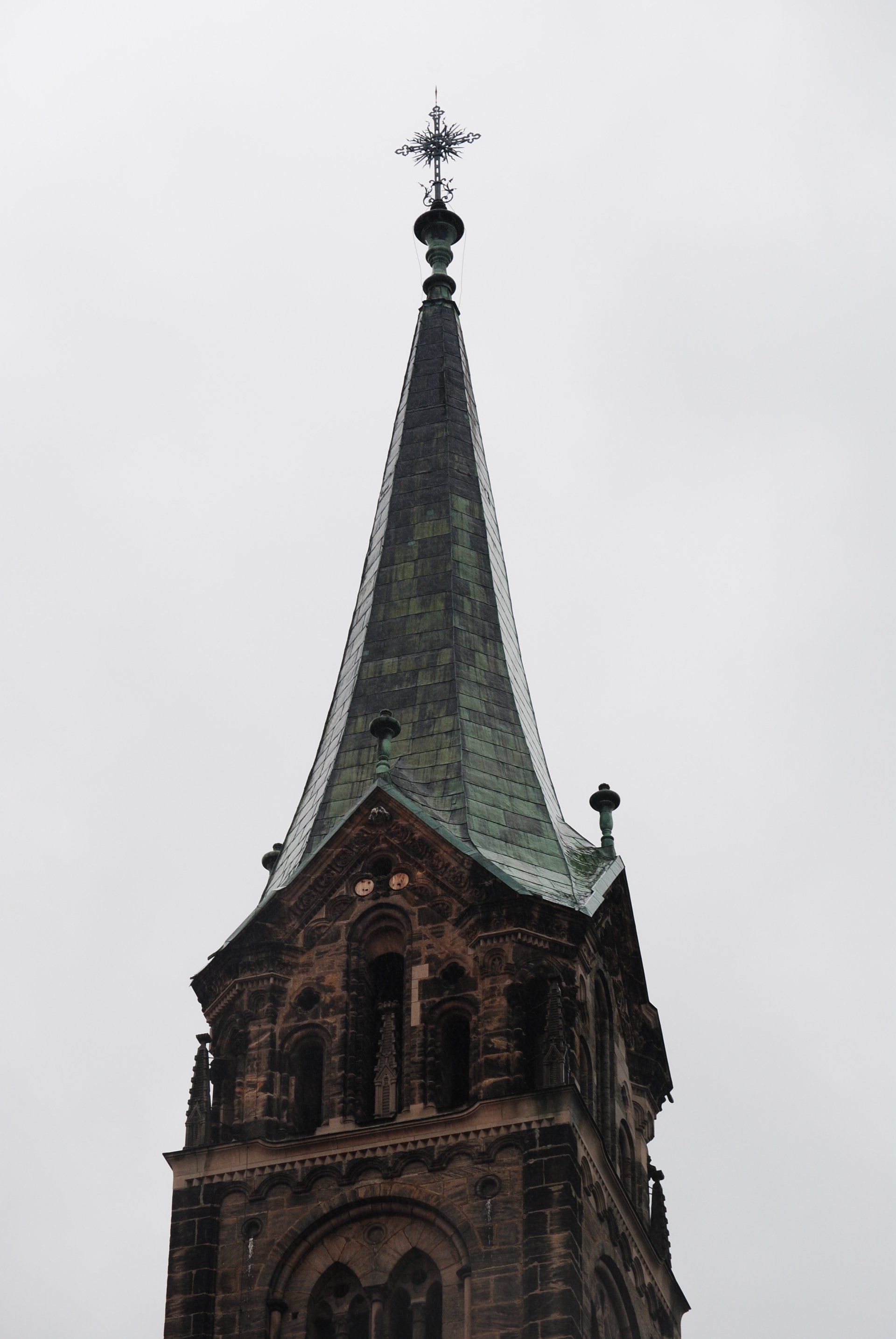 A church steeple with a cross on top of it