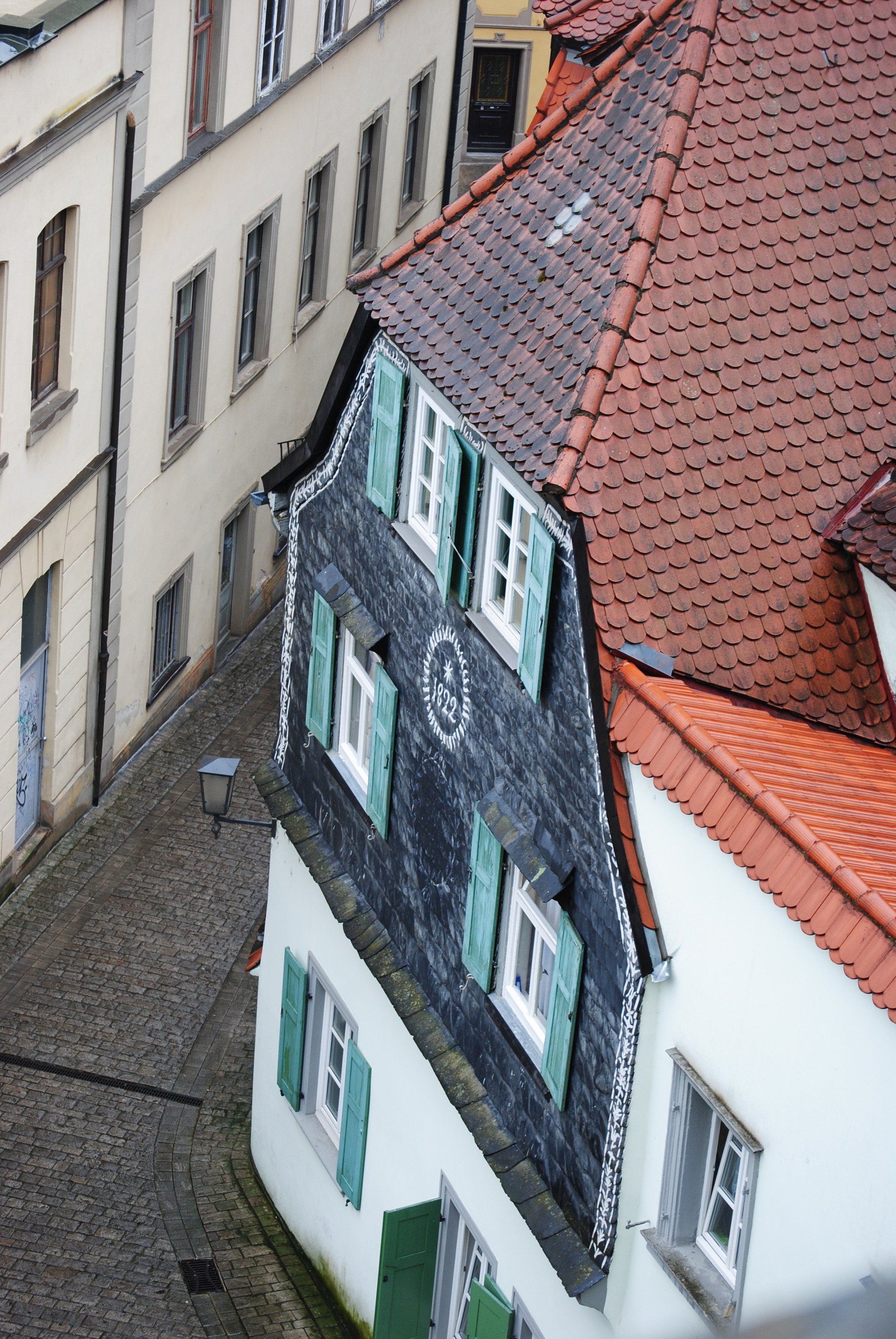 An aerial view of a building with a red tiled roof