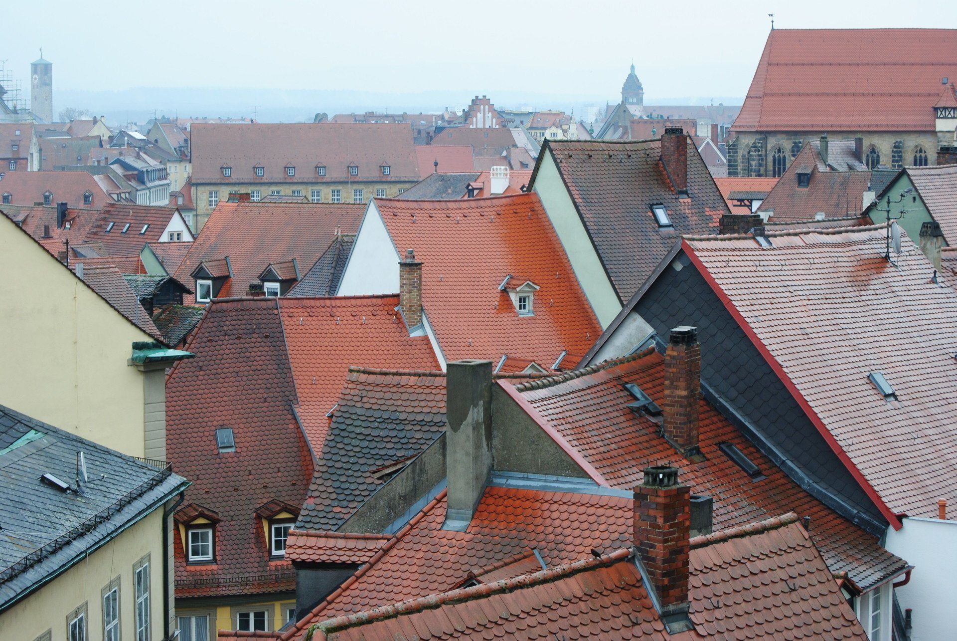 A city with a lot of roofs and chimneys