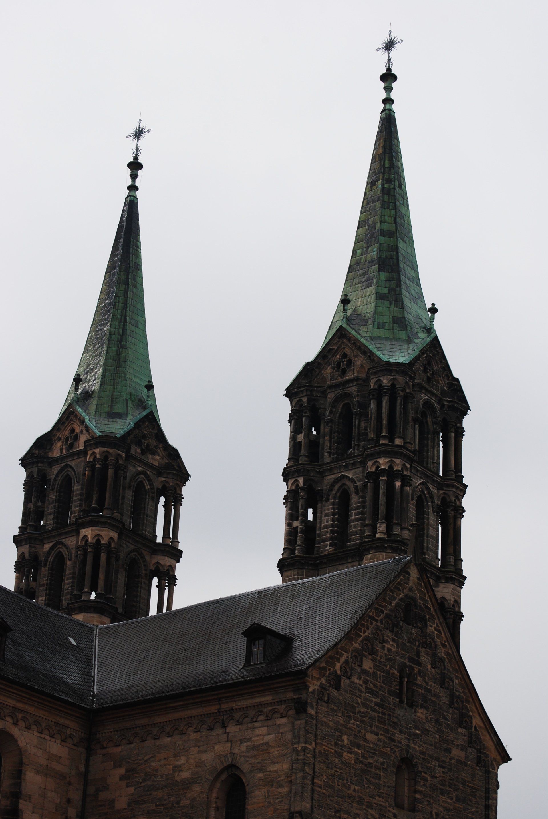 A church with two steeples and a cross on top