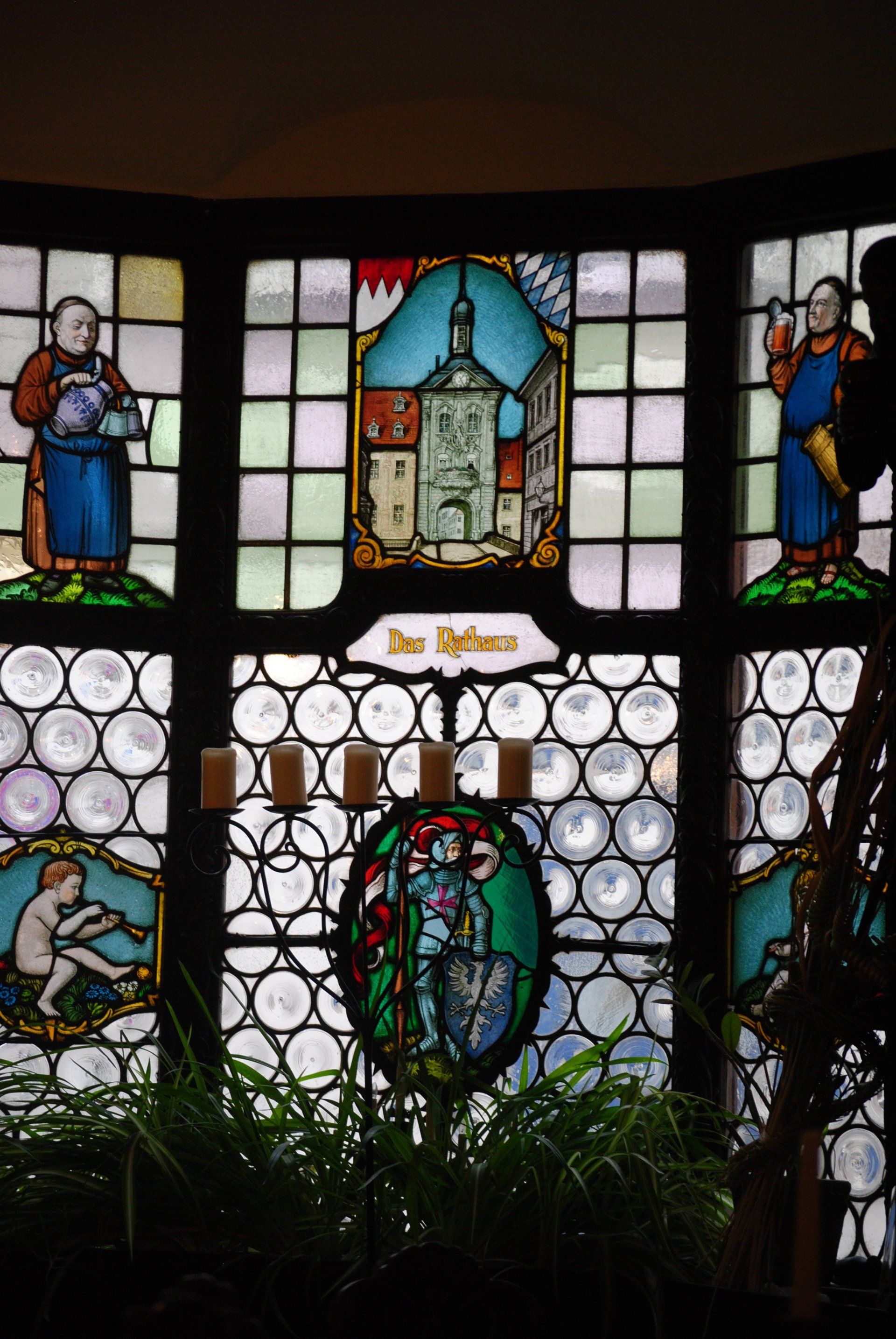 A stained glass window with a castle in the background