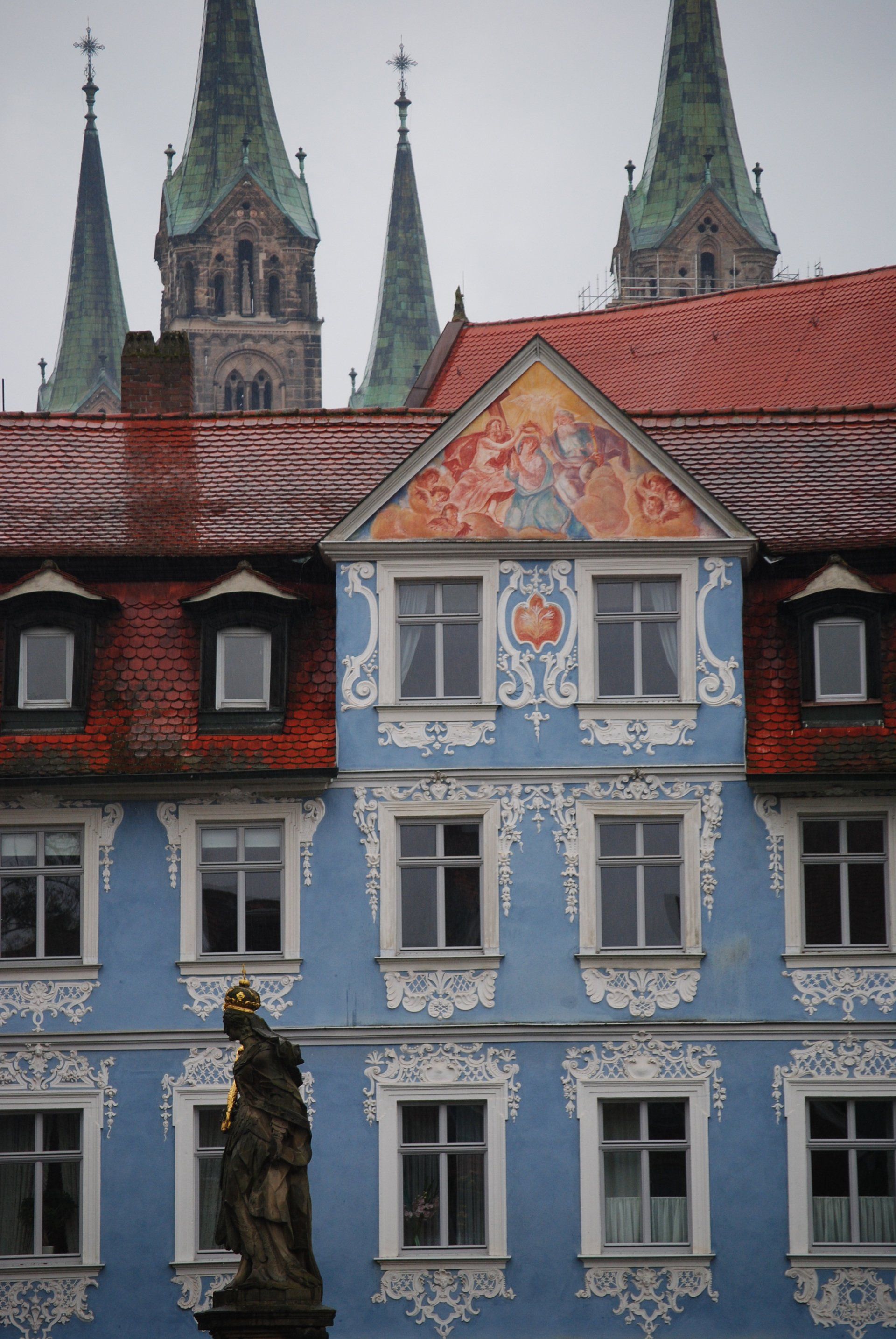 A blue building with a statue in front of it