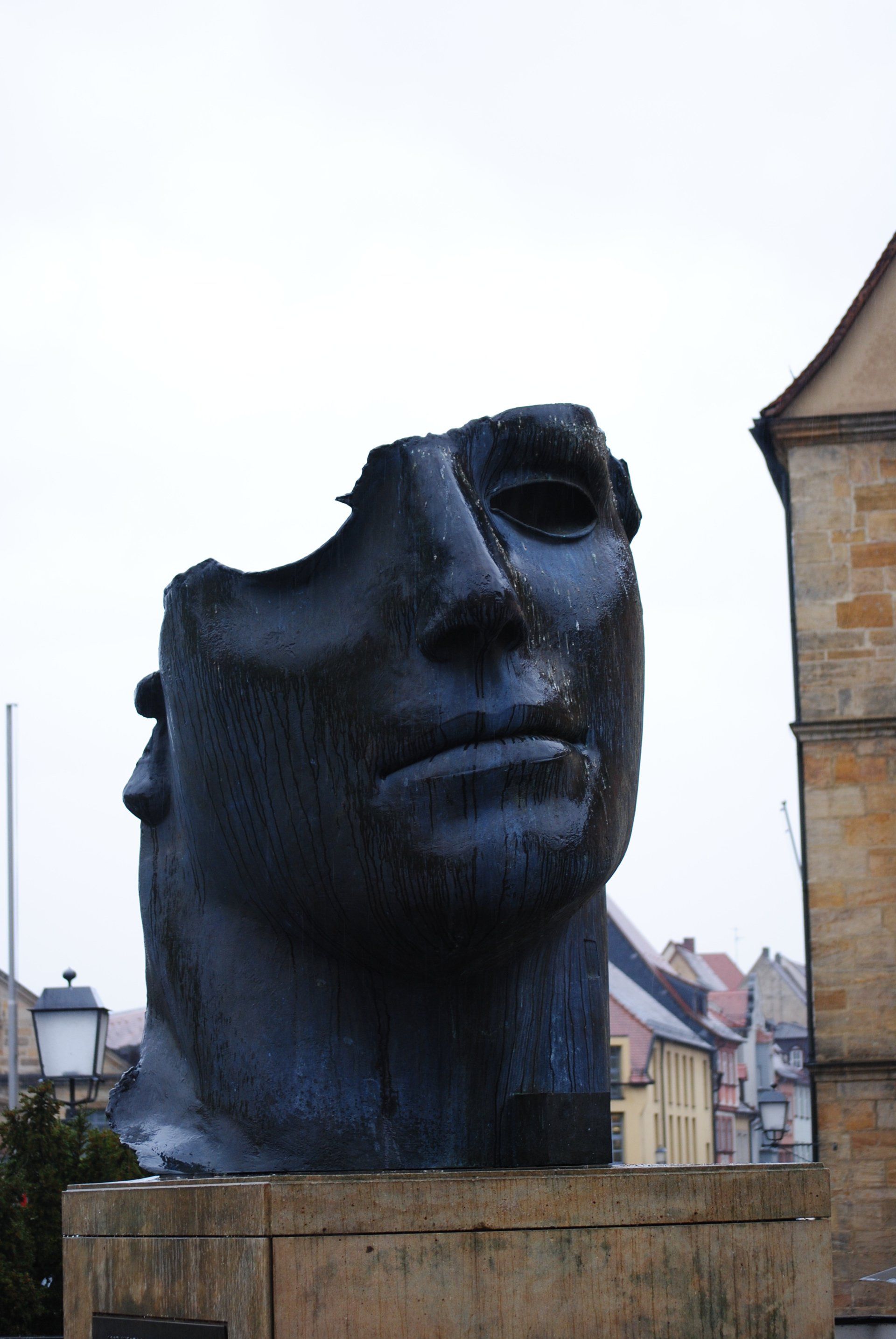 A statue of a man 's head with a hole in it