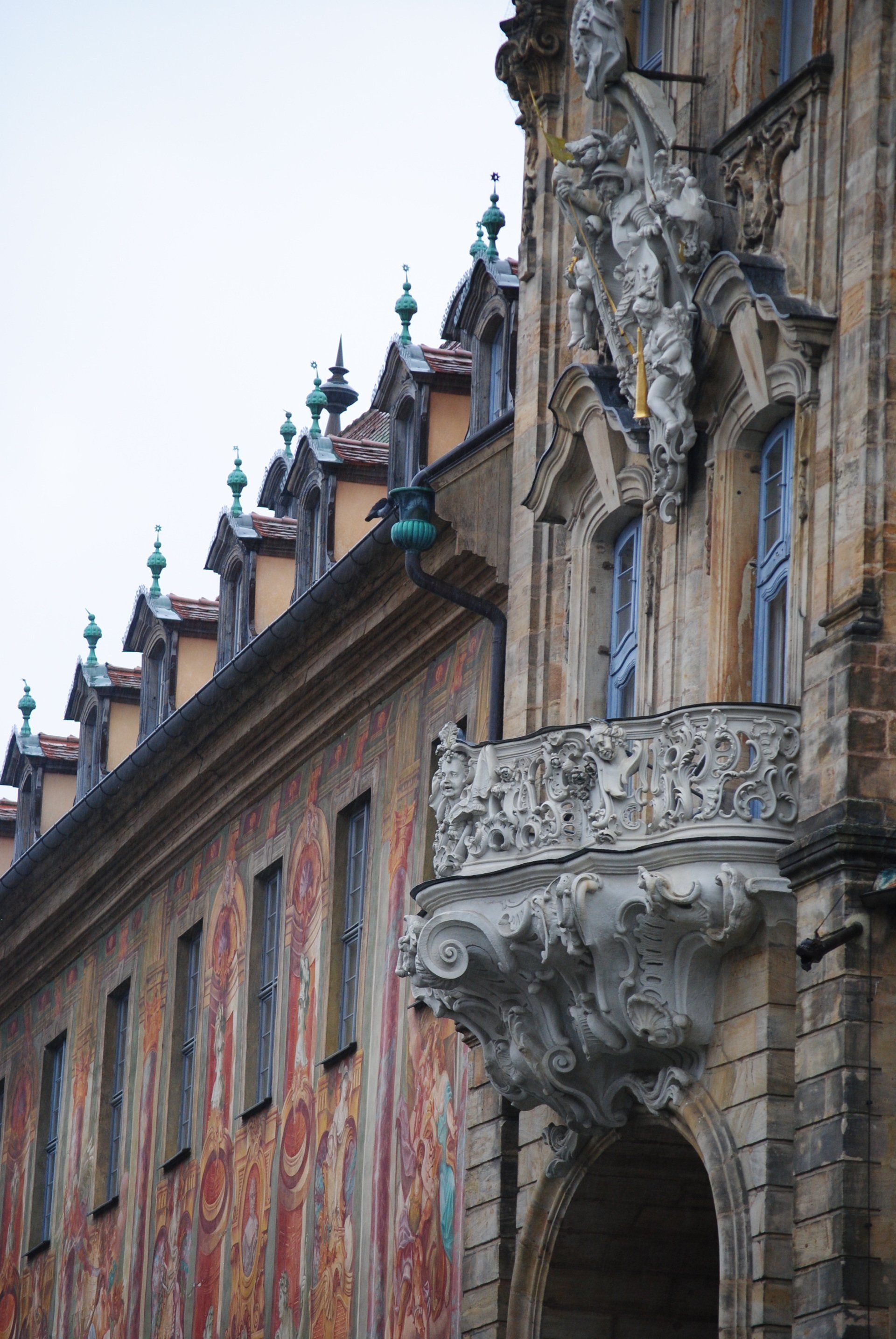 A building with a balcony and a statue on it
