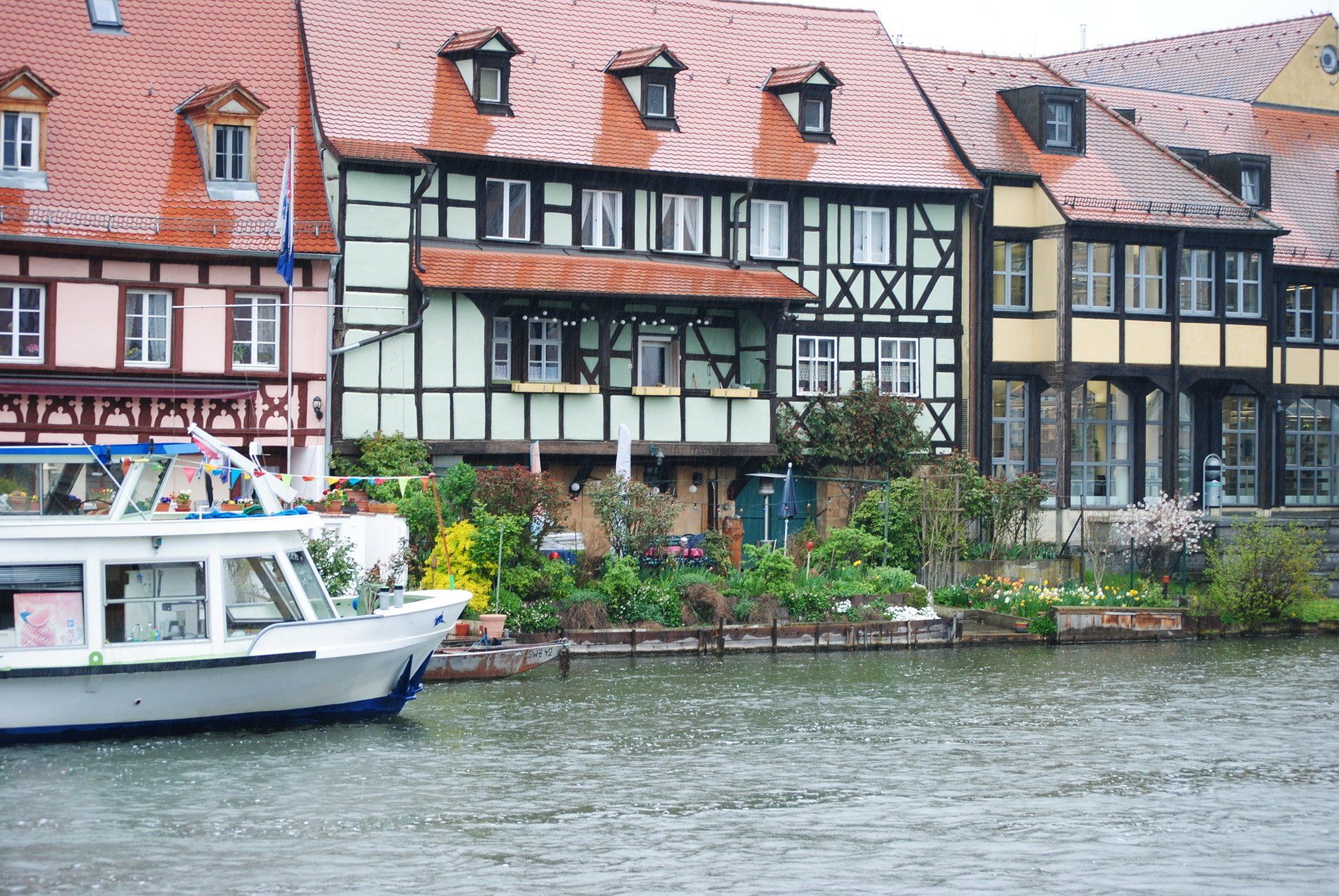 A boat is docked in front of a row of buildings