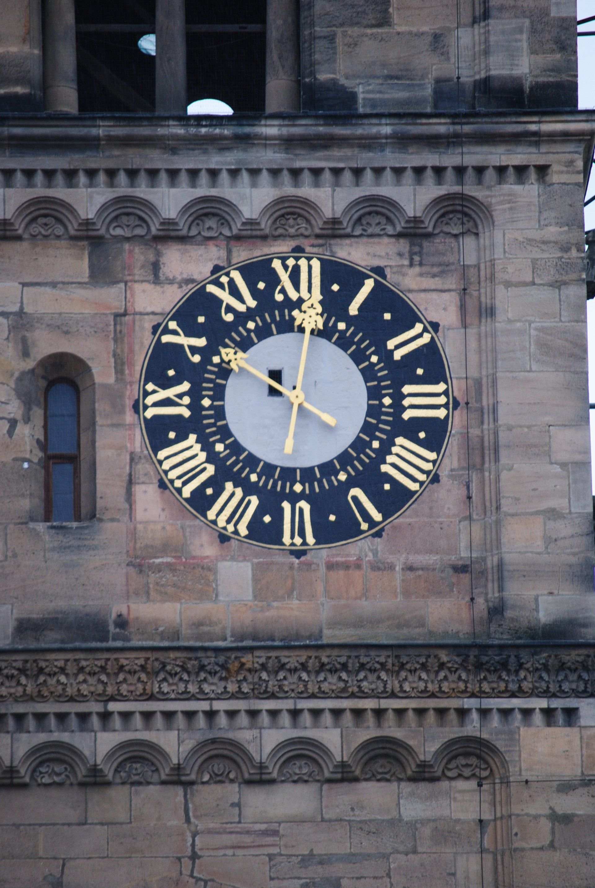 A clock on the side of a building with roman numerals